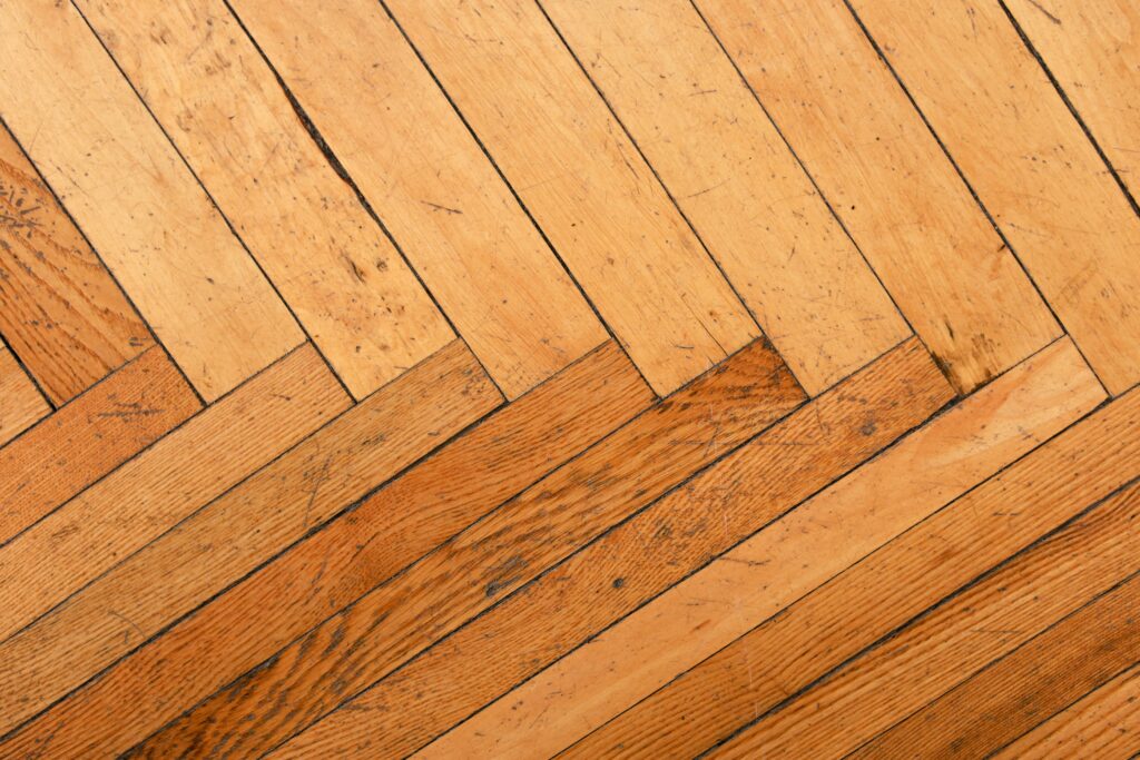 Cross-section diagram of hardwood floor layers showing subfloor, joists, and hardwood planks